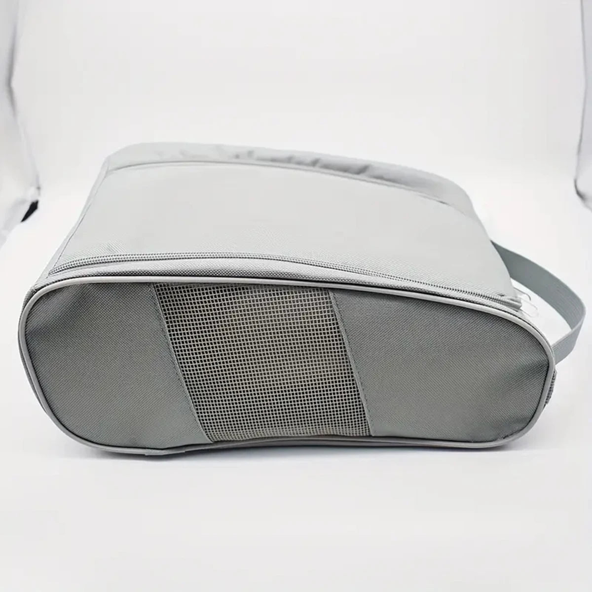 A gray portable shoe carrier bag with a mesh panel on the front, shown from a top-down angle.