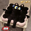 A black cartoon toast seat cushion with yellow eyes is shown resting on a light-colored chair.