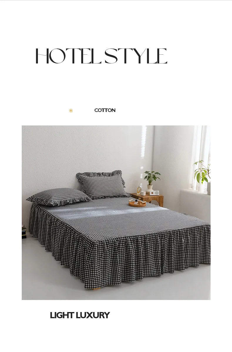 A bed dressed with a black and white plaid cotton skirt cover in a light luxury bedroom setting.
