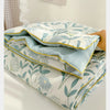 A stack of light blue and white patterned Summer Gauze Cotton Quilt bedding.