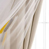 A sheer beige curtain with embroidered wheat stalks in yellow and gray, shown partially drawn.