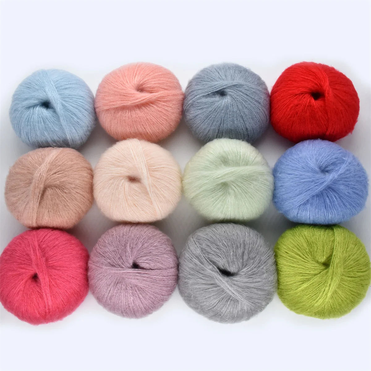 A collection of colorful premium mohair yarn skeins in various shades including red pink blue and green