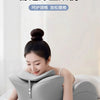 A woman is relaxing on a bed using a gray ergonomic memory foam wedge pillow for comfort and relaxation.