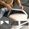 A hand is shown adjusting the elastic band on a gray sofa seat cushion cover, highlighting its stretch and durability.