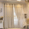 Cream and white dual-layer blackout curtains with eyelet tops hanging in a window.