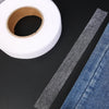 Roll of double-sided heat-resistant interlining tape next to a piece of denim fabric.