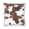 A square cushion cover featuring a brown and white cowhide print.