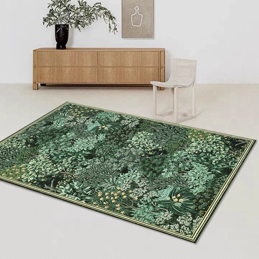 A rectangular dark green botanical area rug with gold trim placed in front of a wooden cabinet and a white chair.