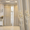 Elegant cream dual-layer blackout curtains with eyelet tops framing a bright interior window.
