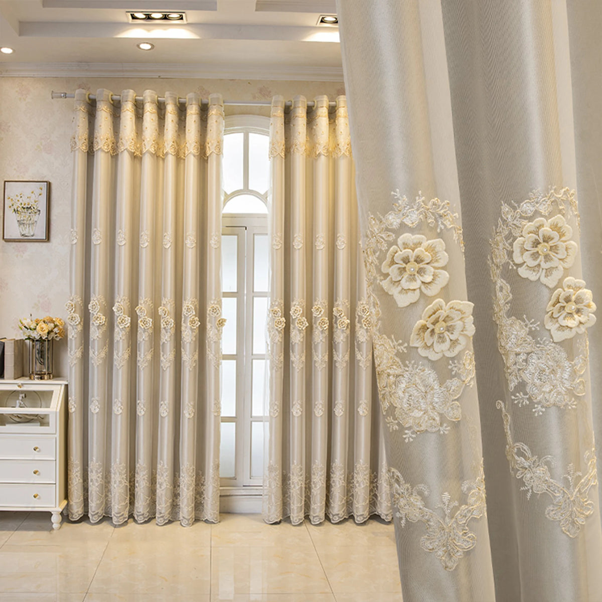 Elegant cream dual-layer blackout curtains with eyelet tops framing a bright interior window.