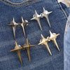 A set of silver and gold Y2K star clips for fastening jeans and skirts