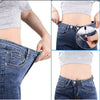 A set of metal jeans button repair kit with a screwdriver shown on denim fabric.