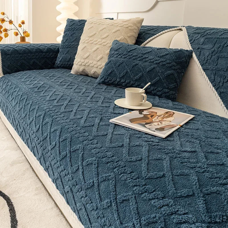 A deep teal plush sofa cushion cover with a quilted texture and cream accent pillows.