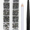 A clear plastic case containing various sizes and colors of crystal hot fix rhinestones and an applicator tool.