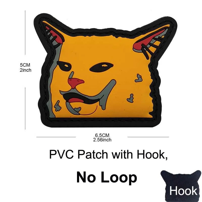 A yellow cat face patch with black outline and a hook for attachment.