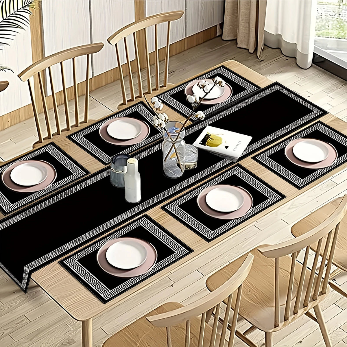 A set of luxury geometric placemats and a table runner displayed on a wooden dining table with place settings.