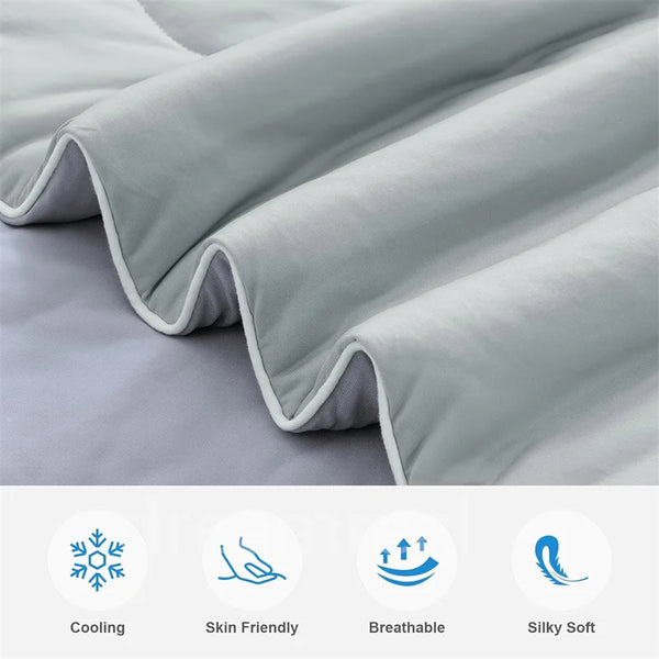 A close-up of a light gray blanket folded and draped, highlighting its soft texture and breathable features.