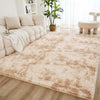 A fluffy cream tie-dye shaggy rug placed on a light wood floor in a bright living room setting.