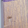 Purple glitter string curtains covering a window or door.