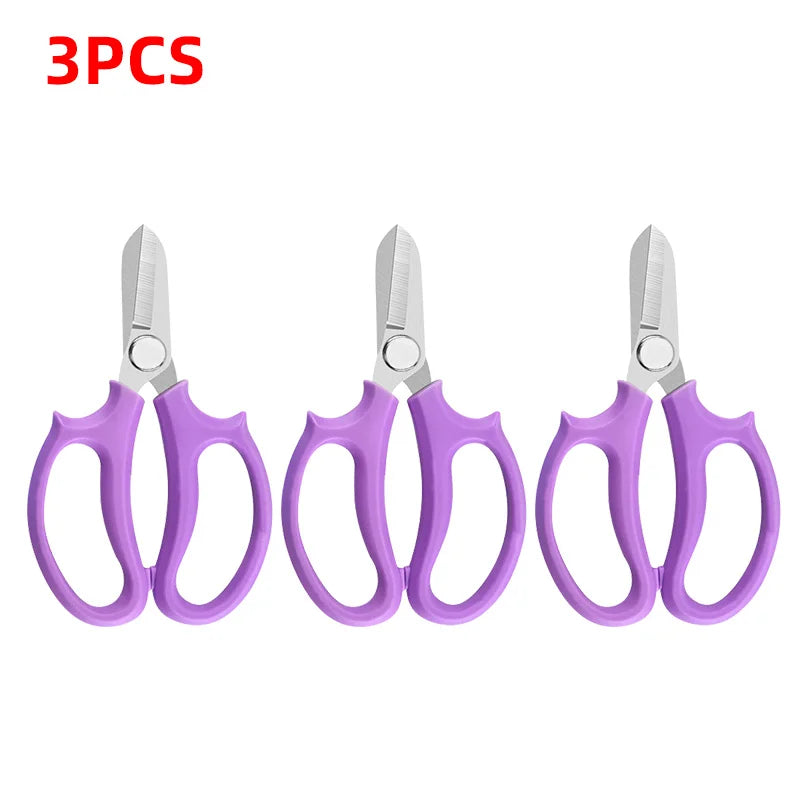 Three pairs of purple precision shears with silver blades shown side by side