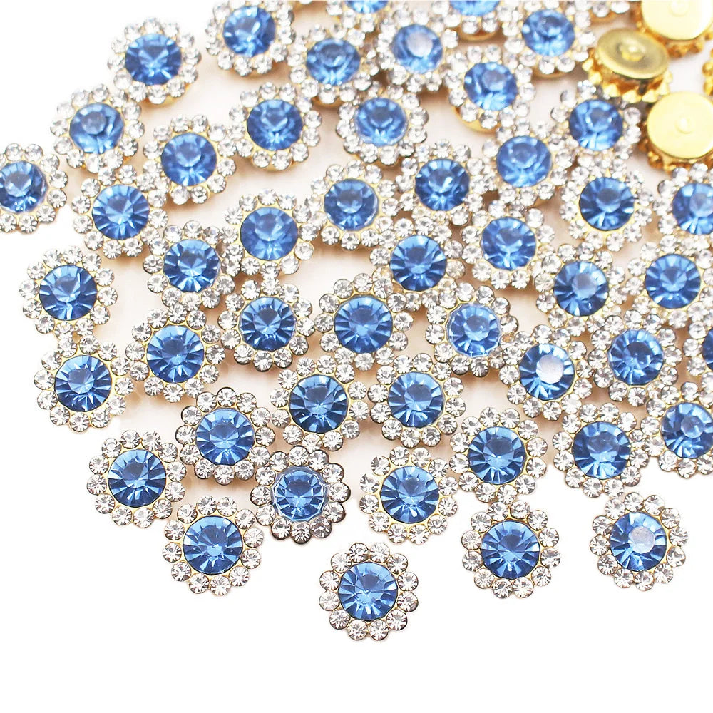 A close-up of sunflower crystal rhinestone sew-on buttons in blue and clear tones.