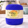 A skein of vibrant blue silk bamboo blend yarn is shown on a white surface.