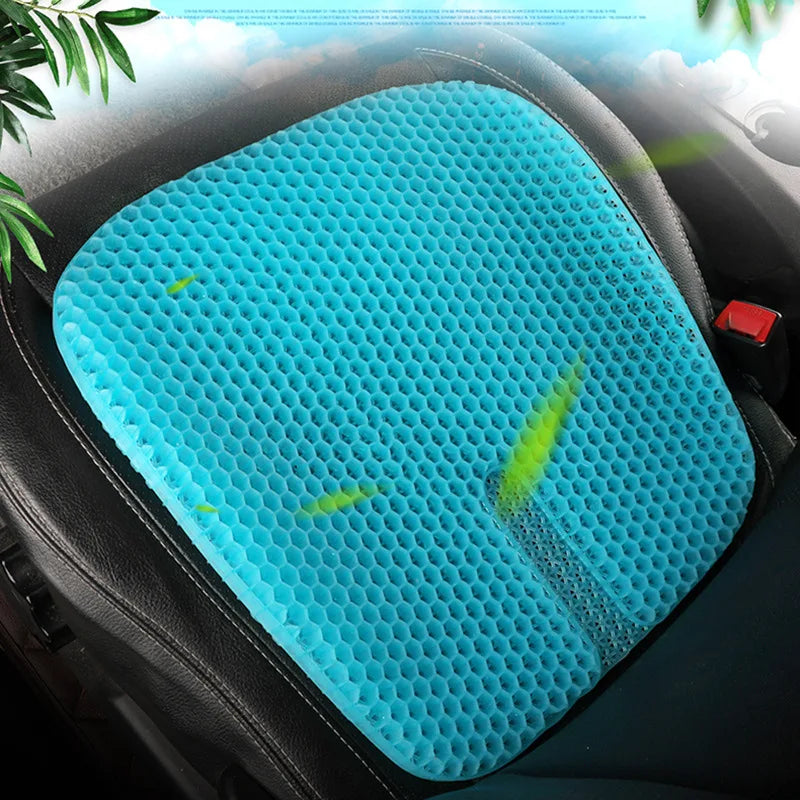 A bright blue, honeycomb-textured ergonomic cooling seat cushion is placed on a black car seat.
