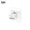 A single self-adhesive curtain rod clip for mounting on windows or walls.