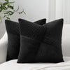A black textured corduroy throw pillow cover is shown on a white surface.