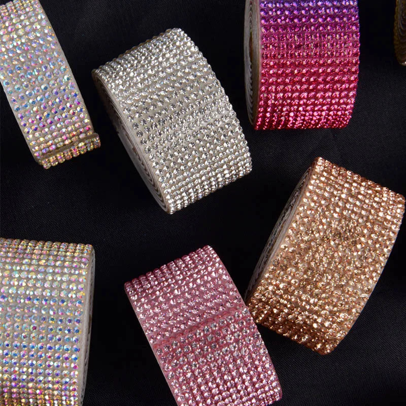A collection of glittery diamond rhinestone strips in silver, pink, and gold for DIY decor.