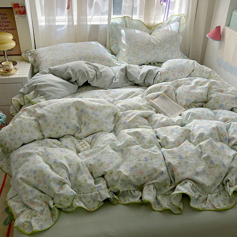 A floral bedding set featuring light green and white patterned fabric on a bed.