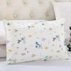 A white cartoon style children's pillowcase with various small animal and nature motifs.