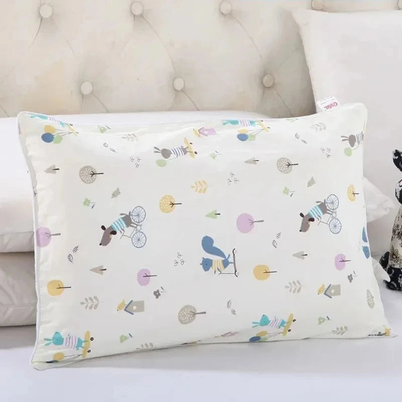 A white cartoon style children's pillowcase with various small animal and nature motifs.