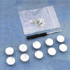 A clear plastic bag contains several silver metal button pins on a blue denim fabric background.