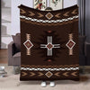 A dark brown flannel throw blanket featuring an ethnic geometric print with white and gold accents.