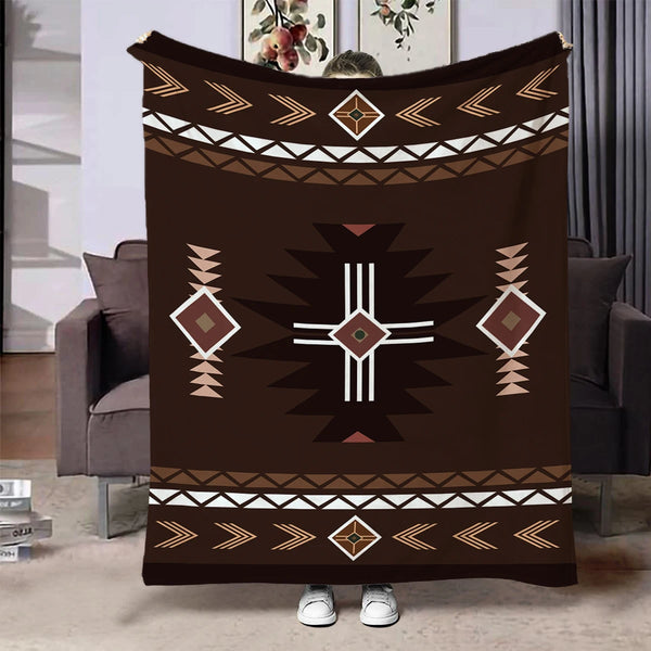A dark brown flannel throw blanket featuring an ethnic geometric print with white and gold accents.