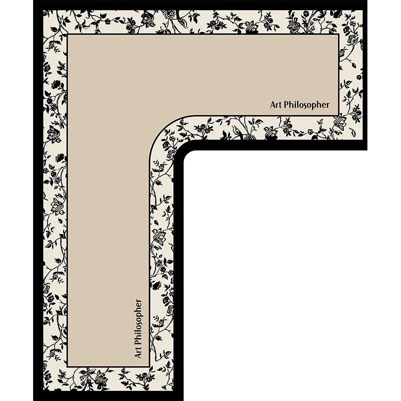 A rectangular floor mat with a beige center panel framed by black and white floral patterns.