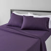 A purple microfiber flat fitted sheet set with white pillows on a bed.