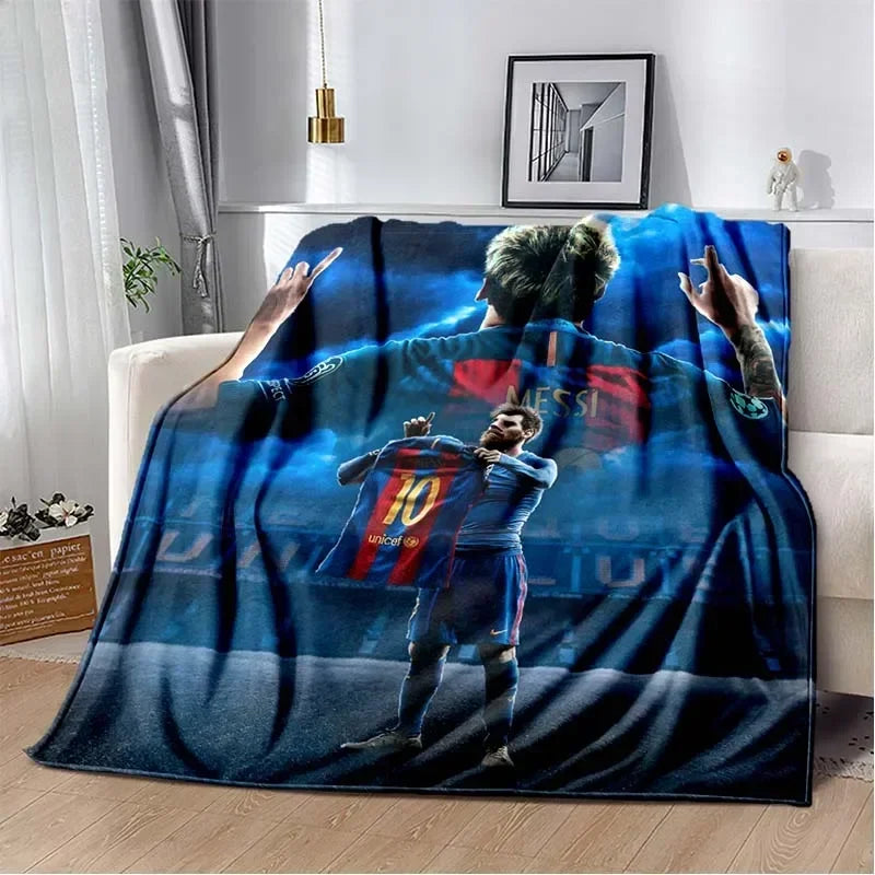 A blue football-themed blanket featuring a soccer player in a jersey and a fan's hand pointing.