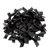 A pile of black satin ribbon bows for craft and decoration.