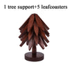 A wooden tree support with five leaf coasters made of dark brown wood.