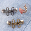 Silver and gold adjustable leaf clover waist tightener jewelry displayed on denim fabric.