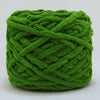 A ball of bright green chenille knitting yarn with an intricate, twisted texture.