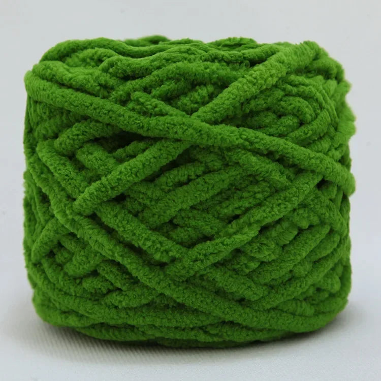 A ball of bright green chenille knitting yarn with an intricate, twisted texture.