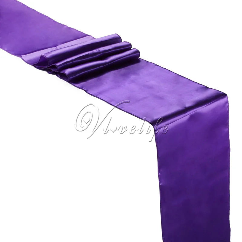 Purple luxury satin table runner draped elegantly for weddings and events