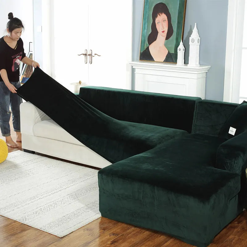A dark emerald green velvet L-shaped sectional sofa in a modern living room setting.