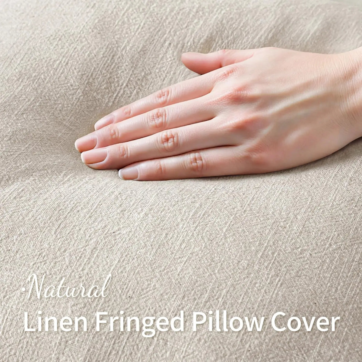 A hand gently touches a natural linen fringed pillow cover in a beige tone.