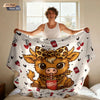 A person is lying down and holding a large flannel blanket featuring a cartoon Highland cow print.