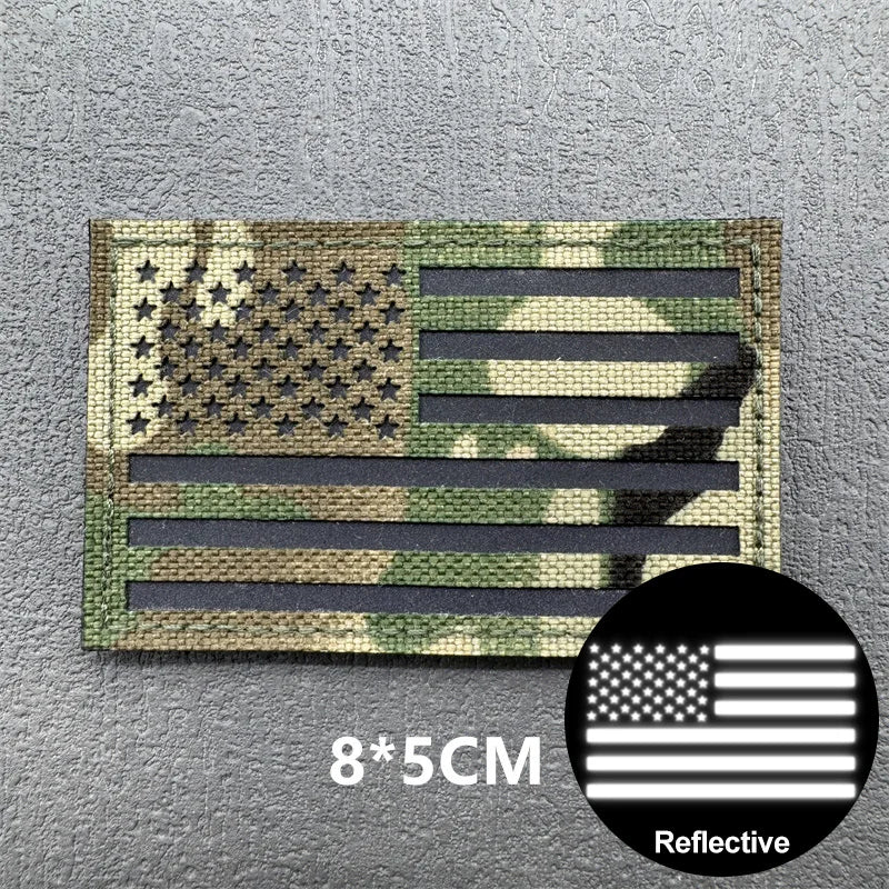 Tactical USA flag patch featuring stars and stripes on a camouflage background with reflective material