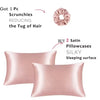 Pink satin pillowcases and a hair scrunchie for reducing the tug of hair